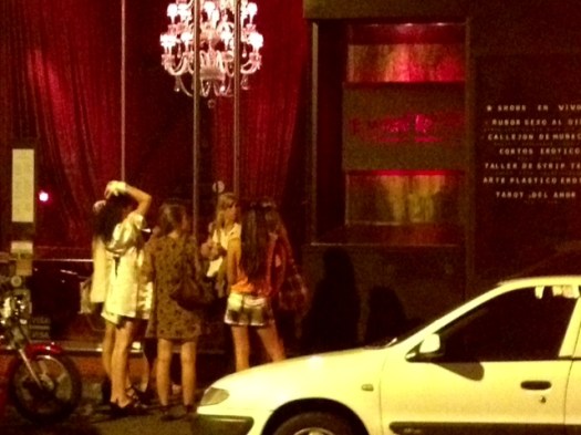 Some chicas all dolled up about to go into an "aphrodisiac restaurant."  Cheezee